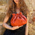 Minibolso pequeño en piel de cordero  en color naranja para mujer
