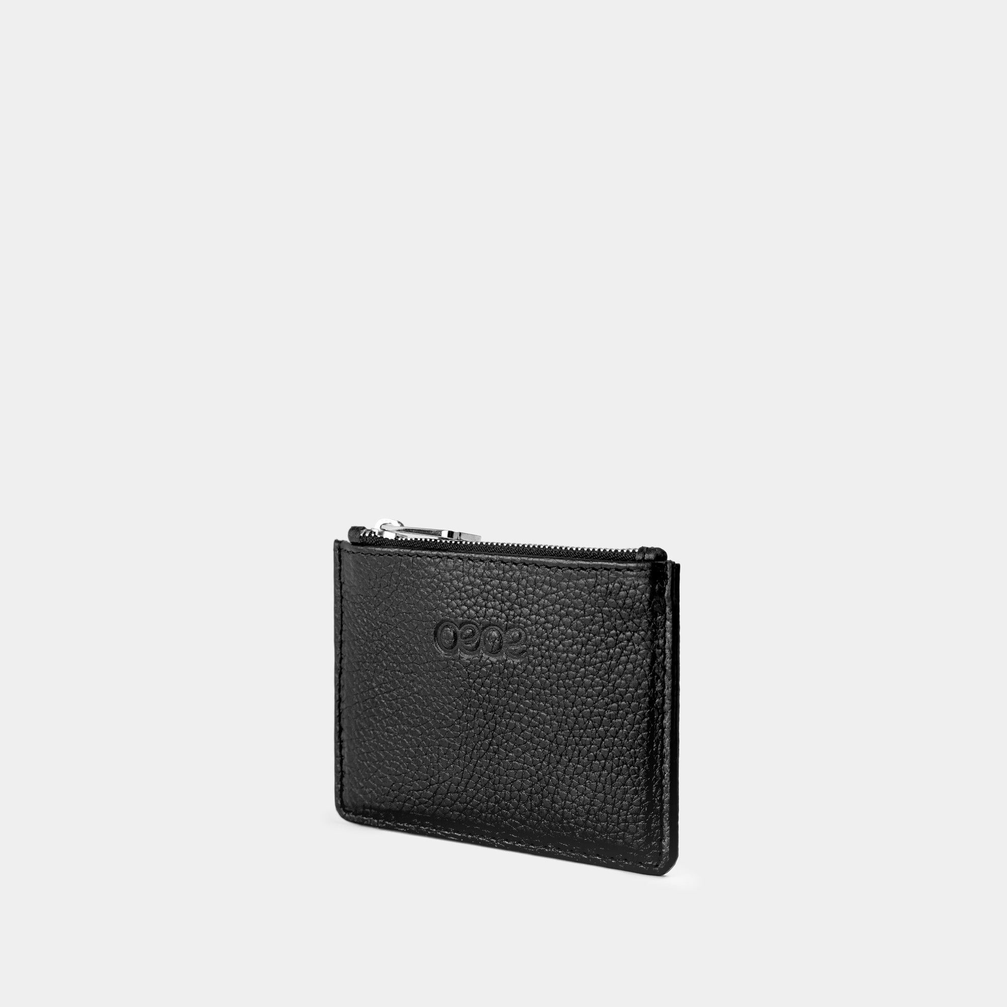 Cartera pequeña en piel de vacuno  en color negro para mujer